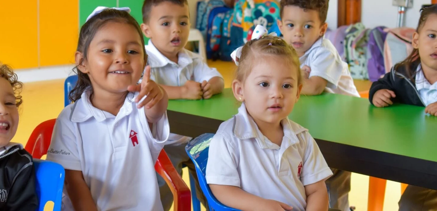 Niños del jardín infantil sonriendo en el salón